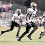 Griffins’ quarterback DeAndre Belton follows lead blockers Malik Mickle (58) and Damian Bell (9) on his way to one of three touchdowns Friday night at Chester.