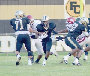 Josh Bell breaks through the line in the first half of play Friday. (Photo/DeAnna Robinson)