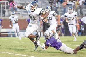 Osei Thomas slips a Blazer tackle. (photo/Kristy Kimball Massey)