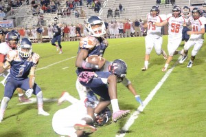 David Isreal breaks a Demon tackle Friday. (Photo/Joe Seibles)