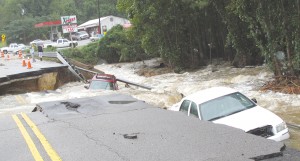 A pair of vehicles plunged into the raging waters Sunday as a 20-foot section of Highway 21 near Lake Elizabeth collapsed under their wheels. The occupants were rescued as the record breaking storm changed the landscape of the Midlands. (Photo/Barbara Ball)
