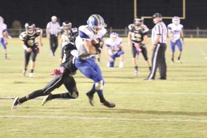 Mitchell Gibbons covers the ball as he bangs into the end zone Friday. (Photo/Martha Ladd)