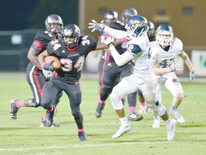 Rudy Mitchell (34) delivers the stiff-arm to Brian Brown. (Photo/Ross Burton)
