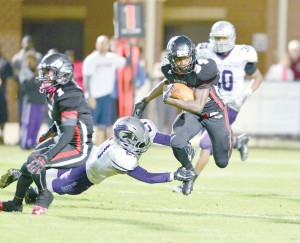 Rudy Mitchell (34) cuts his eyes to his left as he avoids a shoestring tackle Saturday. (Photo/Ross Burton)
