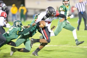 Westwood quarterback Jalen Smith (3) drags a pair of Knights down field. (Photo/Ross Burton)