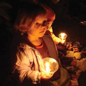 Emma McIntyre lets her little light shine warmly during a chilly Christmas Eve in the Fields.