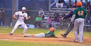Fairfield Central pitcher Lane Floyd (16), cover home on a play at the plate, celebrates after putting the tag on Eau Claire’s Devon Smith. (Photo/Ross Burton)