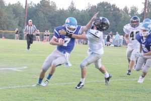 Mitchell Gibbons (7) delivers the stiff-arm on his way to the end zone. (Photo/Martha Ladd)