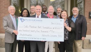 Nick Wodogaza, center, President of Blythewood’s newly opened Palmetto Citizens Federal Credit Union, presents a check for $125,000 for the naming rights to the Town’s new amphitheater to Jim McLean, left, Chairman of the Doko Meadows Park Foundation; Foundation members Martha Crawford and Buddy Price; Wodogaza; Town Councilmen Larry Griffin, Eddie Baughman and Malcolm Gordge; the Town’s financial assistant Chris Keefer and Mayor J. Michael Ross. (Photo/Barbara Ball)